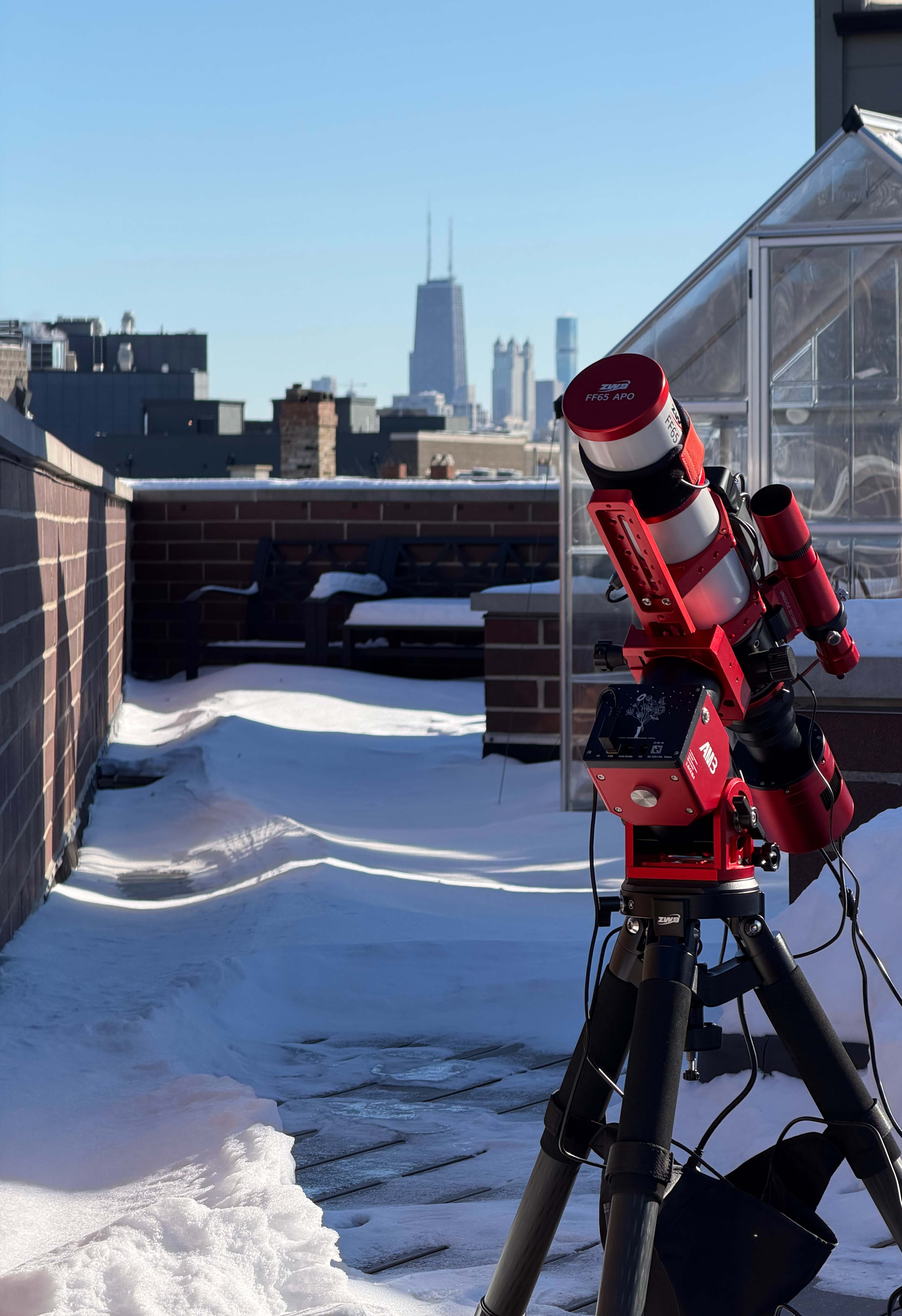 ZWO FF65 telescope on a Chicago rooftop with the city skyline at dusk